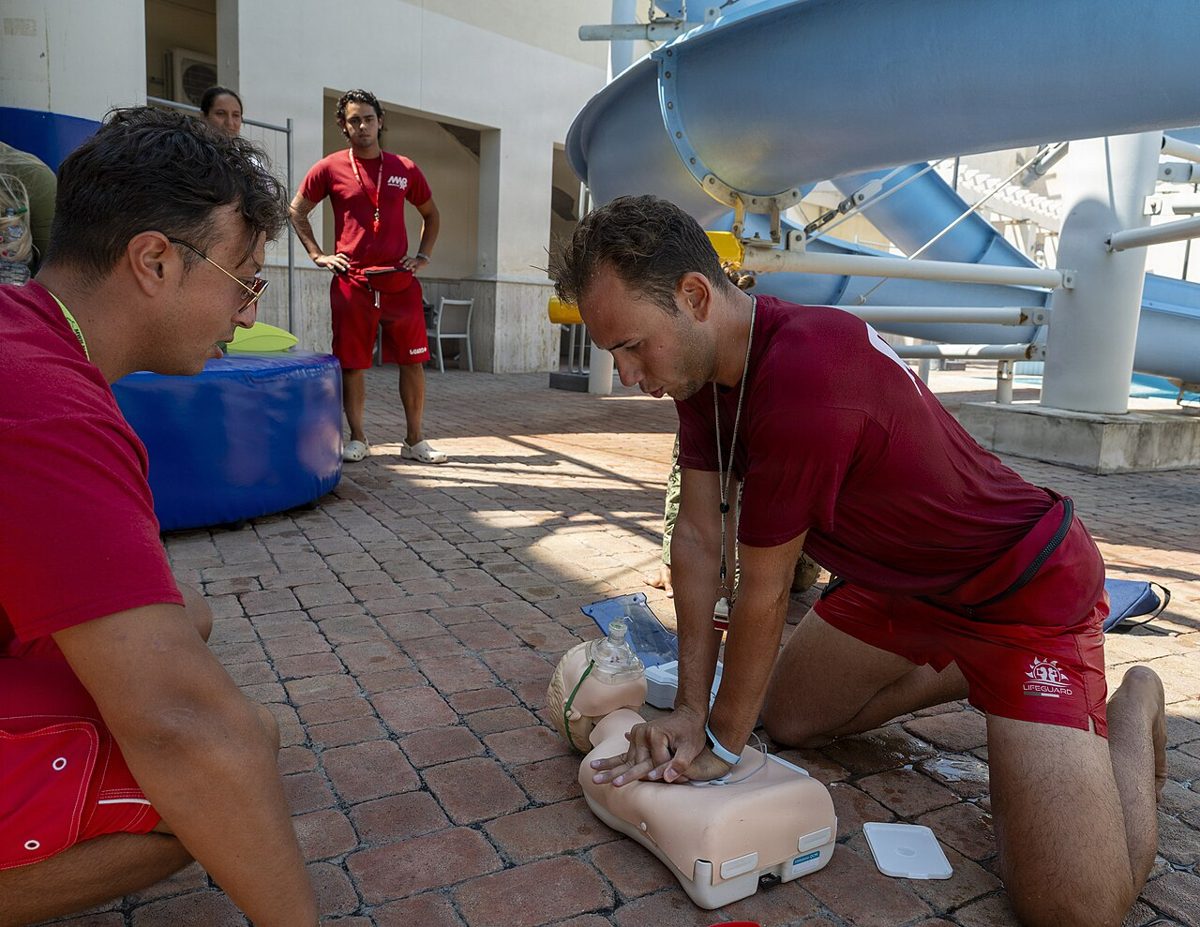 Lifeguards practicing CPR on training mannequins during a certification course