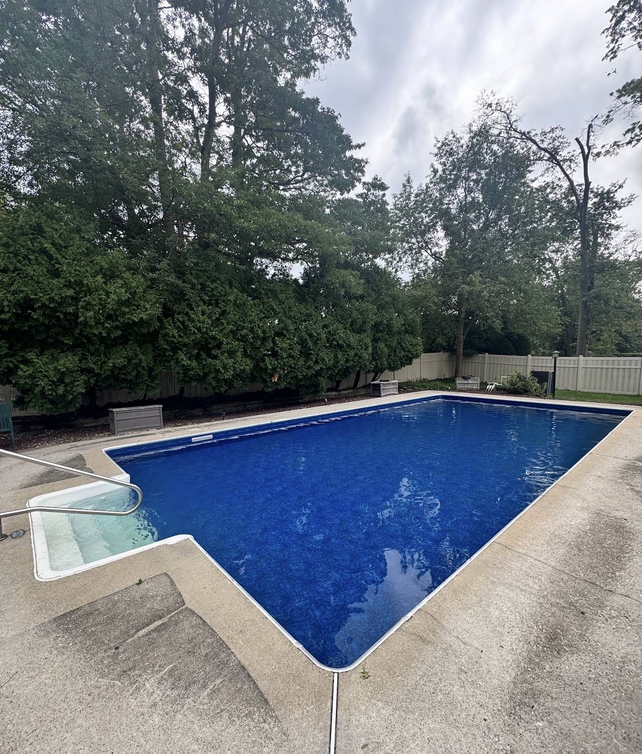 Residential inground pool with deep blue liner